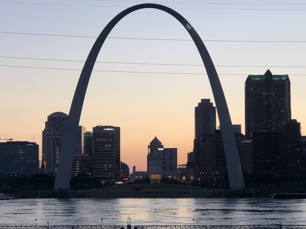 St Louis Gateway Arch and skyline, with Mississippi River in the foreground and sunset in the background